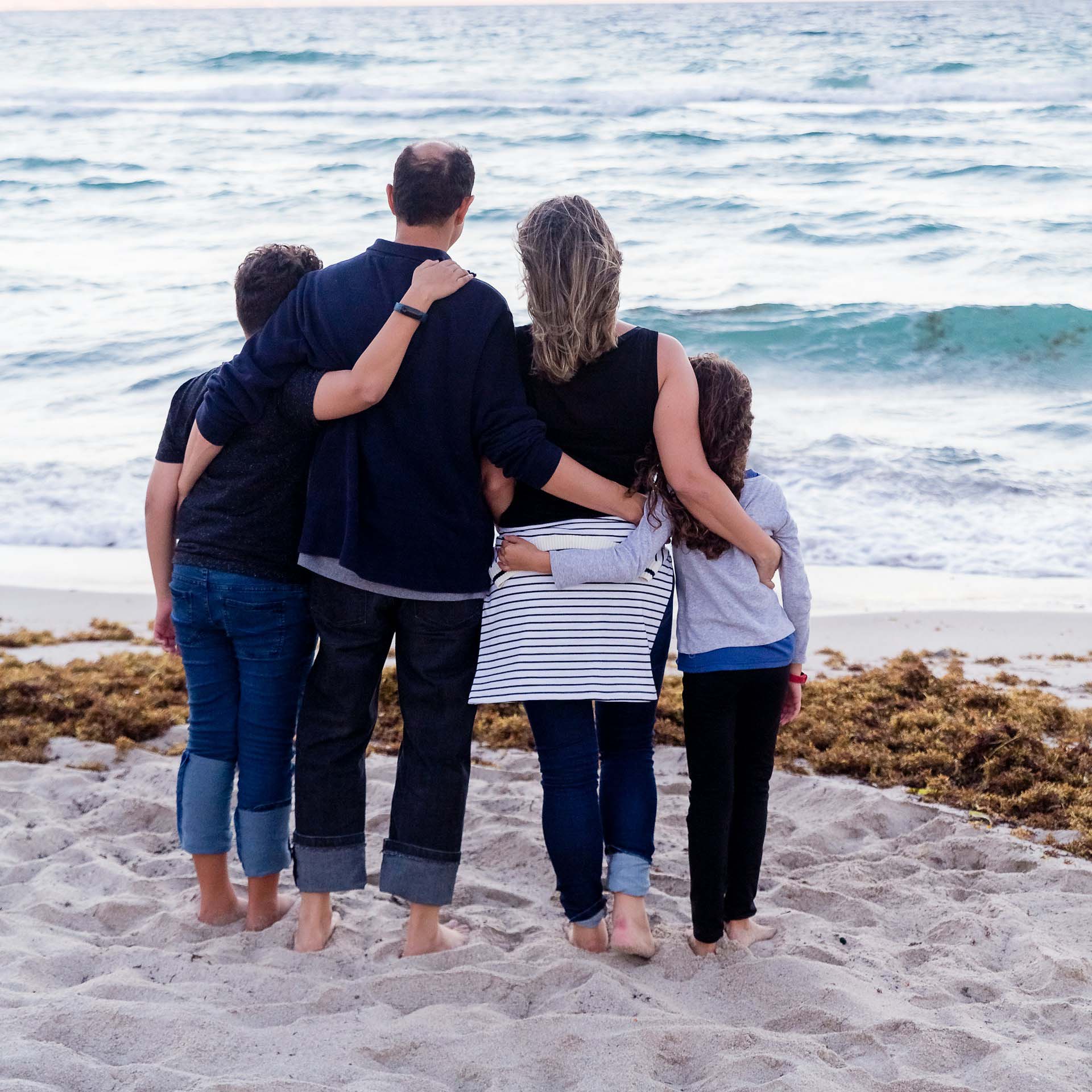 family looking out at ocean