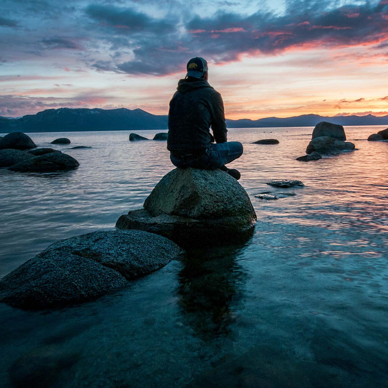 navigating change - guy on rock